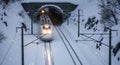 High-Speed Train Emerging from Snowy Tunnel in Winter Blizzard with Falling Snow, Modern Railway Transportation Royalty Free Stock Photo