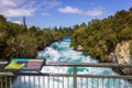 Powerful Huka Falls with a sign with information about the falls, on the Waikato River near Taupo North Island New Zealand Royalty Free Stock Photo