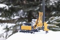 Powerful hydraulic drilling rig for the installation of bored piles in the winter in the snow at the construction site. Drilling