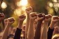 A powerful image of multiple hands raised in solidarity fists, symbolizing a coalition united against a backdrop of ongoing