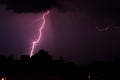 Powerful lightning bolt illuminating the purple night sky Royalty Free Stock Photo