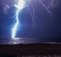 Powerful lightning bolt striking ocean during a storm, lighting up the sky. Royalty Free Stock Photo