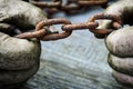 Powerful male hands trying to tear an old rusty chain