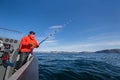 powerful man with a fishing rod in his hands. sea boat. fisherman