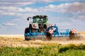 Powerful modern machine for harvesting from the field.  Golden field of ears, barley, wheat and rye, harvesting equipment against Royalty Free Stock Photo