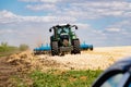 Powerful modern machine for harvesting from the field.  Golden field of ears, barley, wheat and rye, harvesting equipment against Royalty Free Stock Photo