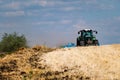 Powerful modern machine for harvesting from the field.  Golden field of ears, barley, wheat and rye, harvesting equipment against Royalty Free Stock Photo