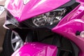 Powerful modern pink bright sport motorcycle, front view.