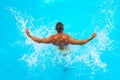 Powerful muscular male figure on blue beach background. Beautiful young man relaxing on beach. Young man Swimming Pool Royalty Free Stock Photo