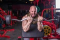 Powerful muscular man doing biceps exercise with barbell on the bench Royalty Free Stock Photo