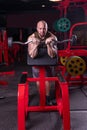 Powerful muscular man doing biceps exercise with barbell on the bench Royalty Free Stock Photo