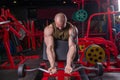 Powerful muscular man doing biceps exercise with barbell on the bench Royalty Free Stock Photo