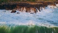 Powerful ocean surf crashing cliff aerial view. Marine swell splashing at coast