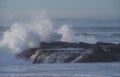 Powerful ocean wave breaks over rock outcrop at Windansea, La Jolla California Royalty Free Stock Photo