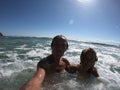 Powerful ocean waves splashing funny couple