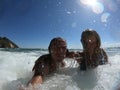 Powerful ocean waves splashing funny couple