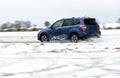 Powerful offroader car sliding by lake ice