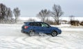 Powerful offroader car sliding by lake ice