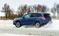 Powerful offroader car sliding by lake ice