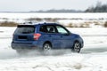 Powerful offroader car sliding by lake ice