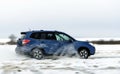 Powerful offroader car sliding by lake ice