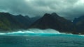 Powerful offshore wind creating large breaking waves near the exotic island.