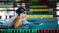 Powerful female swimmer swimming breaststroke at speed