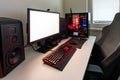 Powerful personal computer gamer rig with white screen. Professsional gaming empty room studio with neon lights and RGB powerful