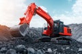 A Powerful Red Excavator Operating on a Construction Site, Digging Deep into the Ground Royalty Free Stock Photo