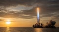 Rocket Launch at Sunset Over the Ocean with Dramatic Clouds and Smoke Plume space shuttle Royalty Free Stock Photo