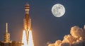 Powerful rocket launch under a bright full moon into the night sky Royalty Free Stock Photo