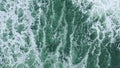 Powerful sea waves foaming drone top view. Stormy grey water making white foam