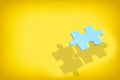 Powerful of shadow of blue puzzle on yellow background