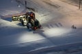 Powerful snowplough clearing parking lot