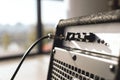 Powerful sound of your guitar. Close-up view of guitar amplifier with cable audio jack. Royalty Free Stock Photo