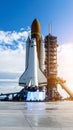 Powerful space shuttle prepared for launch at the gantry under a bright blue sky with engine glow Royalty Free Stock Photo