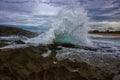 Powerful splash against rock formations