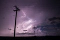 A powerful storm fills the night sky with lightning bolts.