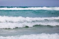 Powerful stormy foamy waves are caught up by the wind