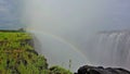 Powerful streams of Victoria Falls crash into the gorge. A rainbow appeared in the thick fog of water.