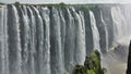 Powerful streams of water fall from the edge of the gorge. Royalty Free Stock Photo