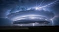 Powerful supercell thunderstorm with dramatic lightning strikes illuminating the dark sky Royalty Free Stock Photo
