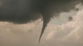 Powerful Tornado Twists Through Dramatic Storm Clouds in the Sky Royalty Free Stock Photo
