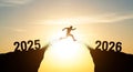 Silhouette of a person leaping across a chasm from 2025 to 2026, symbolizing transition and future progress Royalty Free Stock Photo