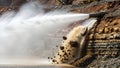 Powerful water jet blasting rocks in a quarry to dislodge them Royalty Free Stock Photo
