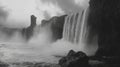 Powerful Waterfall Cascading over Cliffside in Monochrome Royalty Free Stock Photo