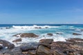 A powerful wave with splashes and foam breaks on a rocky shore. Sri Lanka, near Dondra Lighthouse