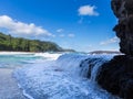 Powerful waves flow over rocks at Lumahai Beach, Kauai