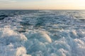Powerful waves and foam astern of a yacht during sunset Royalty Free Stock Photo