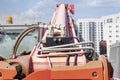 Powerful wheel forklift with telescopic mast at the construction site of a modern residential area. Construction equipment for